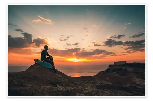 Young man with skate board watching the sunset Editors Choice
